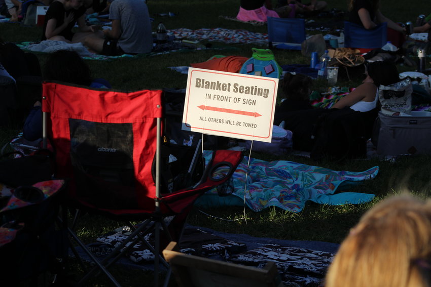 Sunlight falls on a sign denoting blanket-only seating for the Movies & Music in the Park event Aug. 12 at Parfet Park. Hundreds attended the summertime event to see Little Moses Jones perform before a screening of "The Princess Bride."